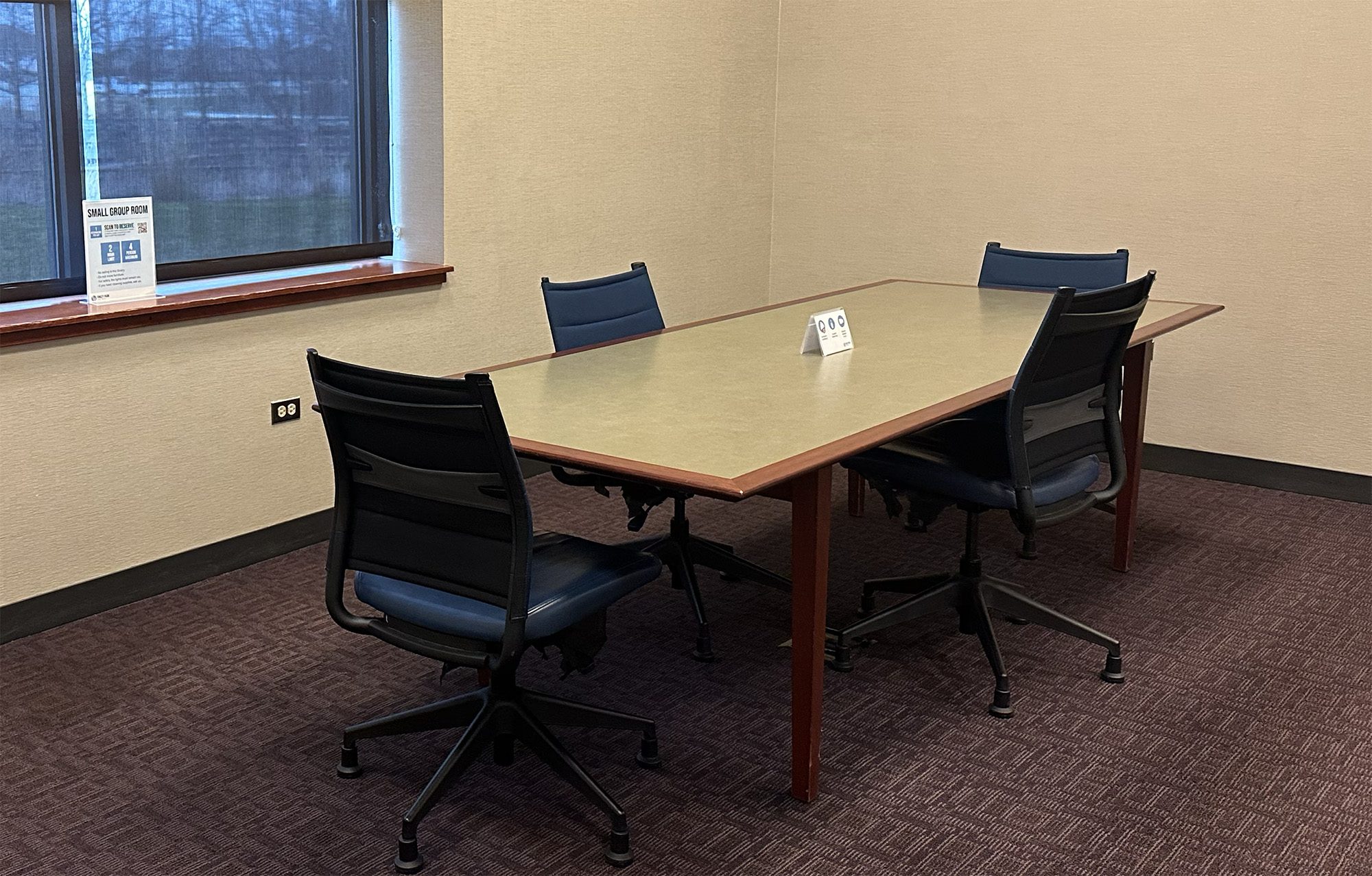 Small group room with table and four chairs
