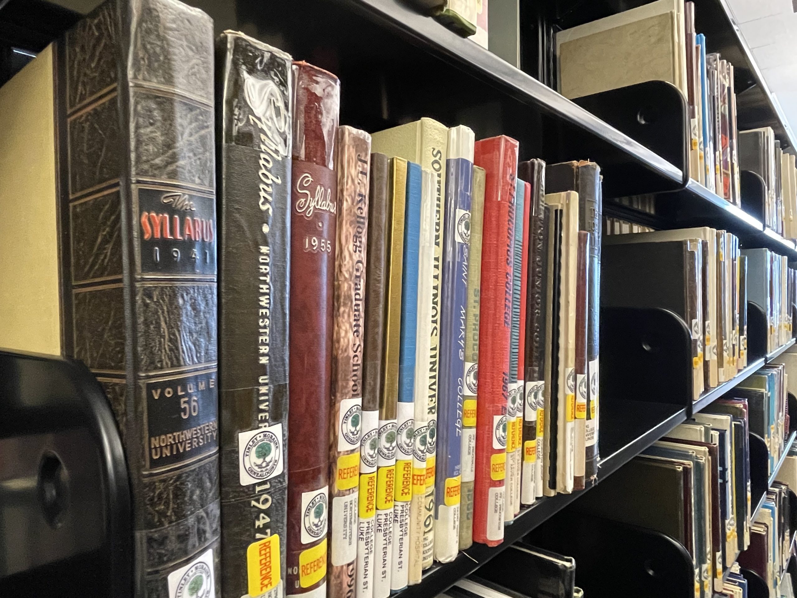 Shelf of yearbooks from local schools