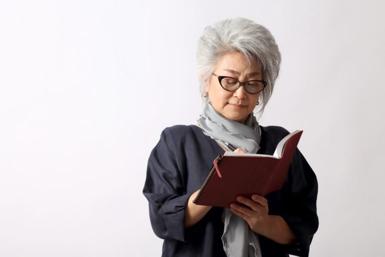 Woman with glasses reading a book
