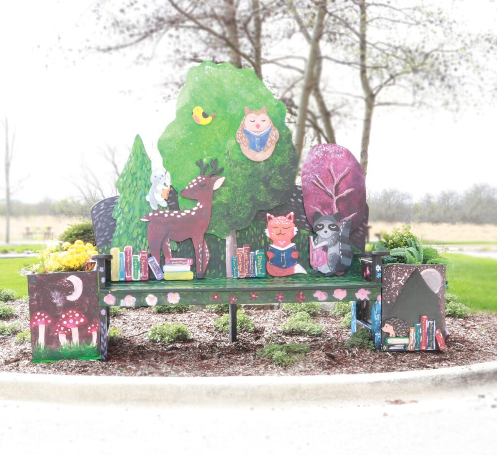 Painted bench with woodland animals reading