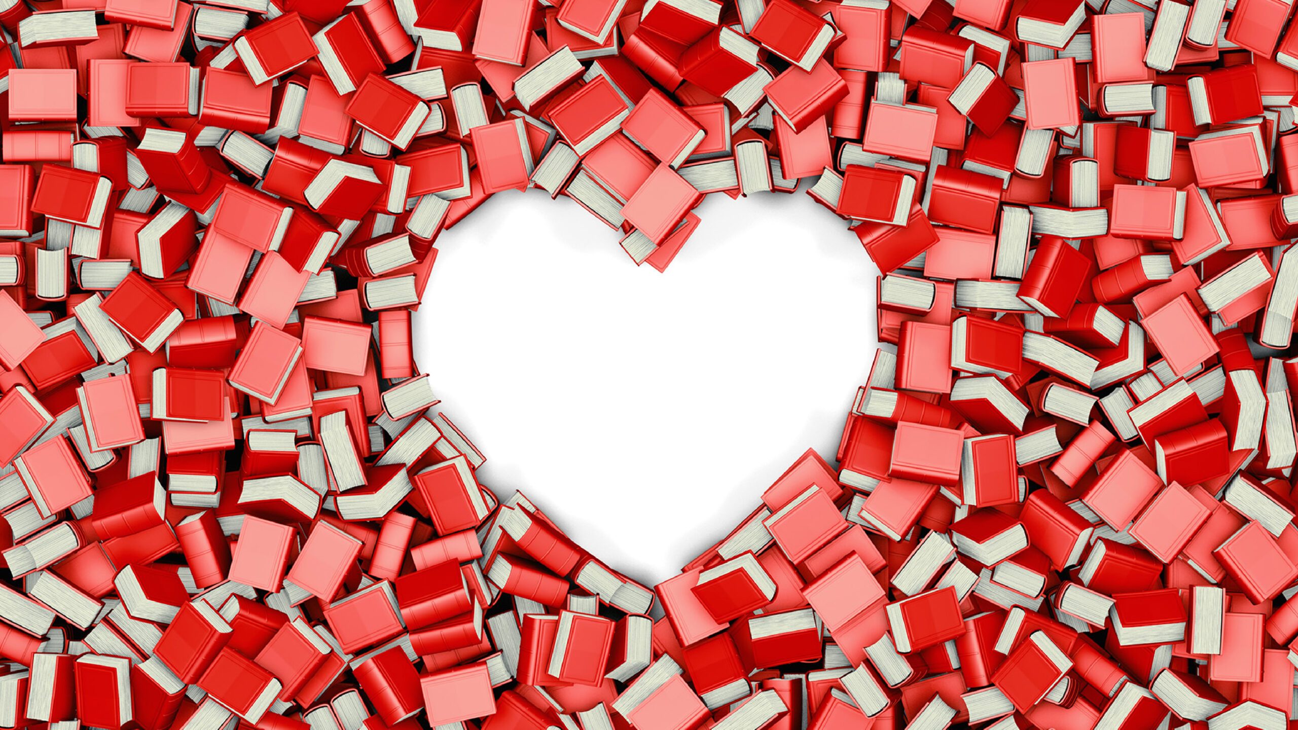 red and pink books scattered around, with a space shaped like a heart in the center