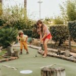 children enjoying a round of mini golf