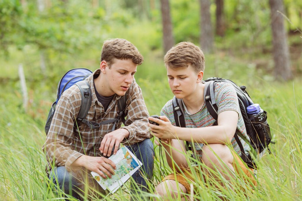 Two guys geocaching outdoors