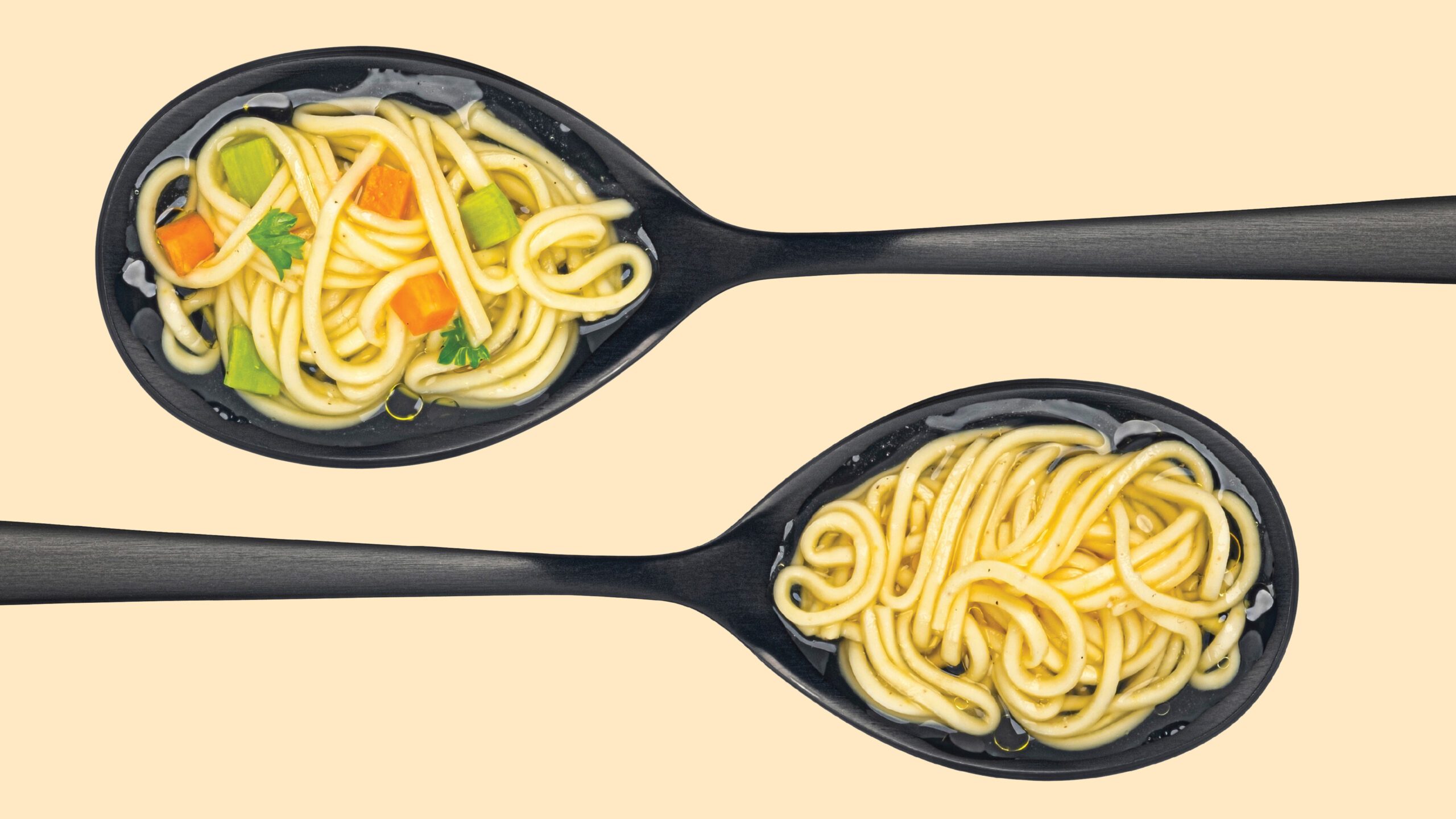 Two spoonfuls of soup with noodles and vegetables