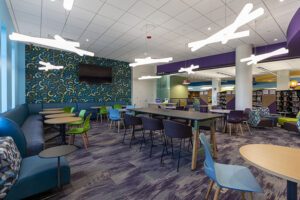 The Teen Study Lounge, a cozy space with chairs and tables for quiet work.