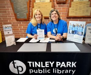 Two library staff members at the Volunteer Fair