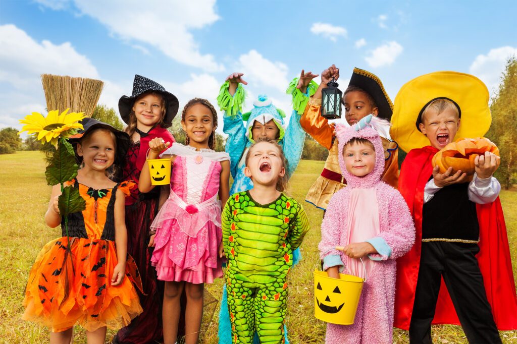 Eight children, each in a different costume, excited for Halloween